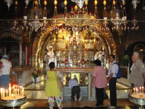 The Altar of the Crucifixion, where the rock of Calvary is encased in protective glass