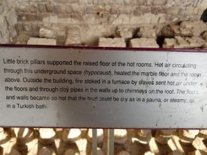 Sign explaining the floor supports for the steam bath at Bet Shean